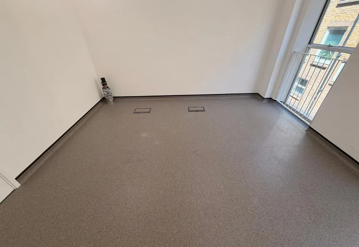 Speckled grey commercial sheet vinyl fitted wall-to-wall in an apartment