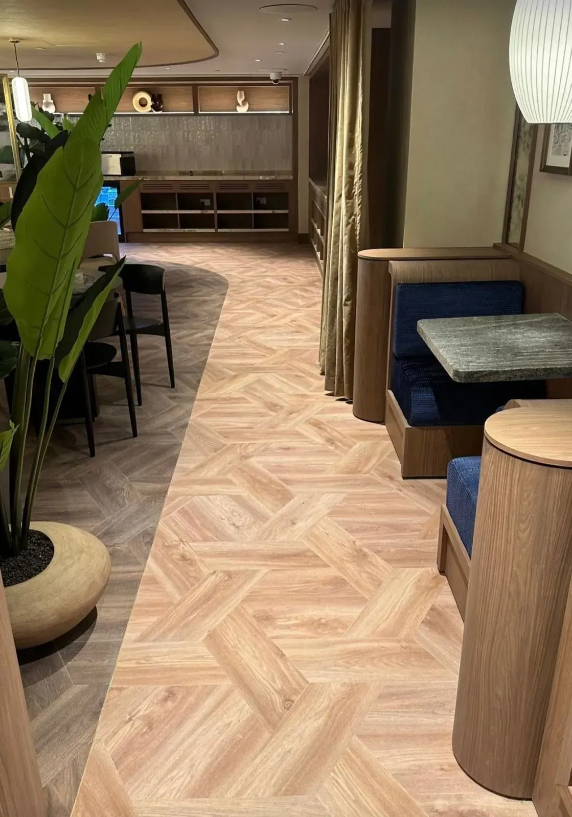 LVT parquet flooring running through the dining area into the booth seating