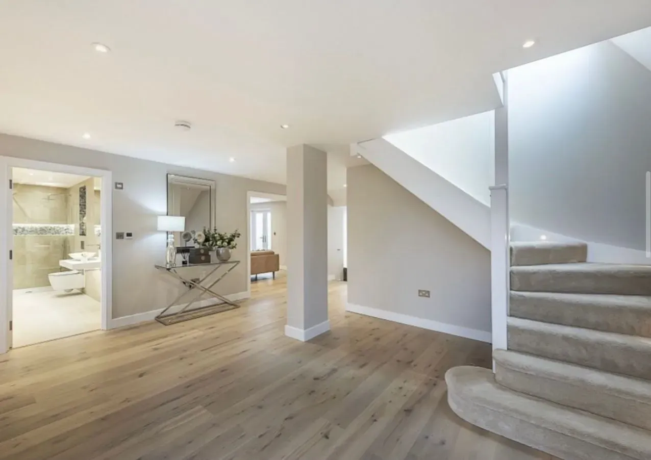 Wide-plank oak flooring flowing through a warmly lit interior